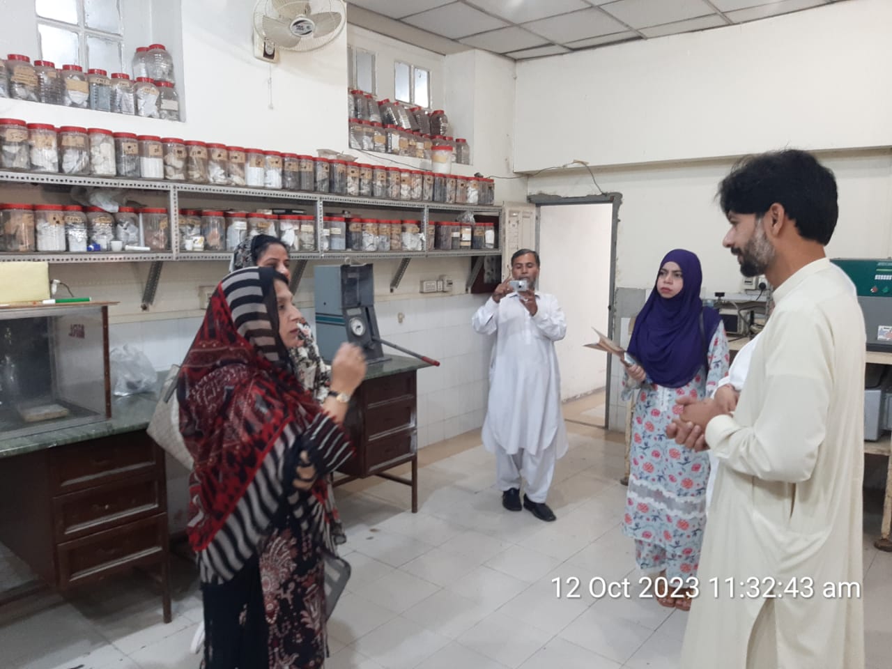 Chairperson M. Ali Sb. in materials Lab. with visiting members